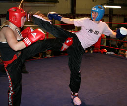 Anne Gallagher kicking high in her debut kickboxing bout in Dublin on October 4