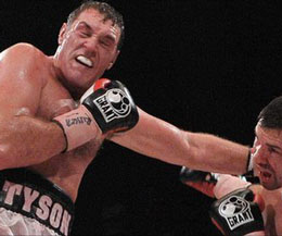 Tyson Fury (left) taking a hard punch in the 3rd then came right back and dazzled Ulster boxing fans with a 5th round TKO