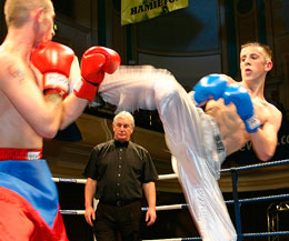 'Kicking all White'  white lands a high kick over Belfast fighter, Aubrey Tarr for British title honours