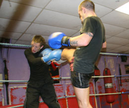 Alexander White takes a kick in the face whilst sparring with world champion Gary Hamilton