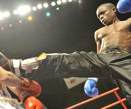 Patrick Kinigamazi kicks out at Belfast's Gary Hamilton