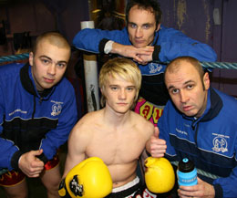 Young Lisburn fighter Mark Bird (center) with his backroom staff