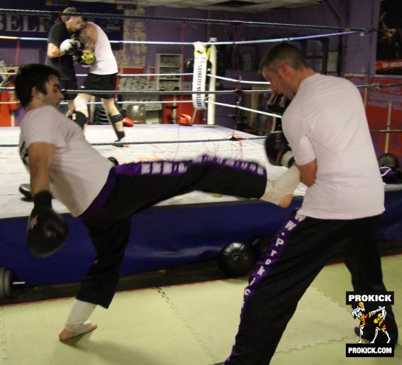 Marc Gillespie throws a front kick while Johnny and Darren make up in the ring.-21