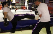 Marc Gillespie throws a front kick while Johnny and Darren make up in the ring.-21