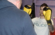 Stephen Fisher holds Pads for Boxing prctise 