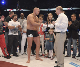 Russian President Vladimir Putin (R) shakes hands with heavyweight mixed martial art fighter Fedor Emelianenko during his visit to St.Petersburg June 21. With K1 star Ernesto Hoost looking on