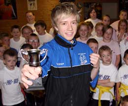 Ryan Dougal with some of the Prokick junior members that he helps to coach every Saturday morning - Ryan received 3 A's in his A levels