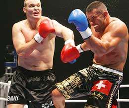 K-1 Grand Prix champion Semmy Schilt delivers a hard left hand after taking a kick from Jerome Le Banner